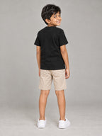 Little Kaavo kids crew tee in black, plain back, worn by a young boy, back view
