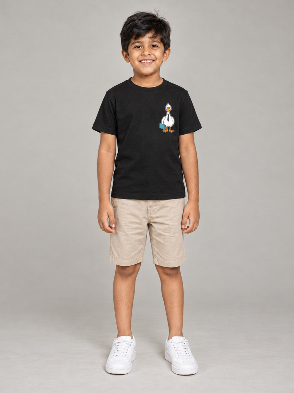 Little Kaavo kids crew tee in black, small duck pocket print, worn by a young boy, front view