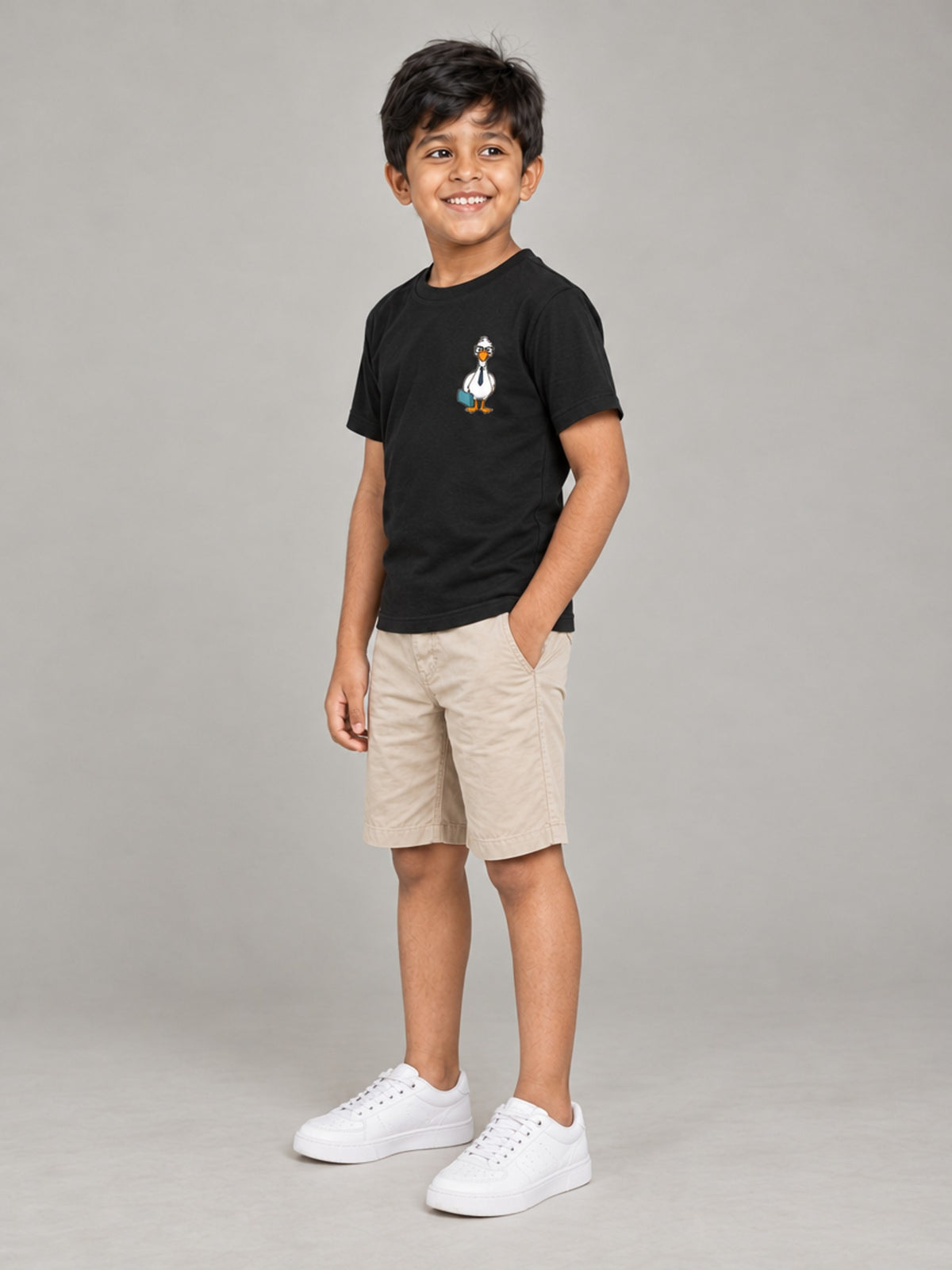 Little Kaavo kids crew tee in black, worn by a young boy, side view showing the fit